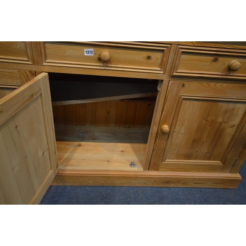 1212 - A PINE DRESSER with seven assorted drawers and triple cupboard doors, width 153cm x depth 43cm x hei... 