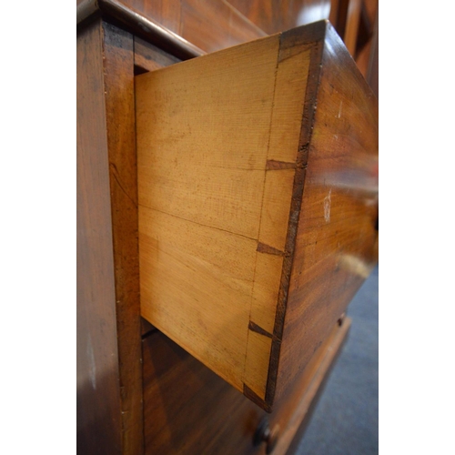 1214 - A VICTORIAN FLAME MAHOGANY LINEN PRESS, overhanging cornice, the double panelled doors enclosing thr... 