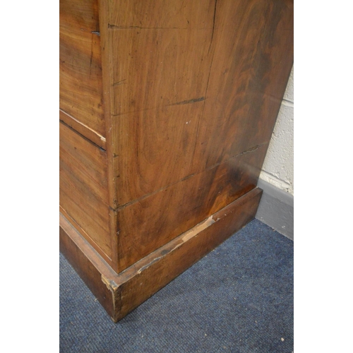 1214 - A VICTORIAN FLAME MAHOGANY LINEN PRESS, overhanging cornice, the double panelled doors enclosing thr... 