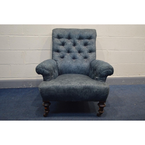 1240 - A VICTORIAN SROLLED AND BUTTON BACK ARMCHAIR in blue floral upholstery, on turned mahogany front leg... 