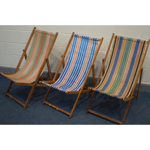 1249 - A SET OF THREE 1970'S FOLDING DECK CHAIRS with stripped fabric