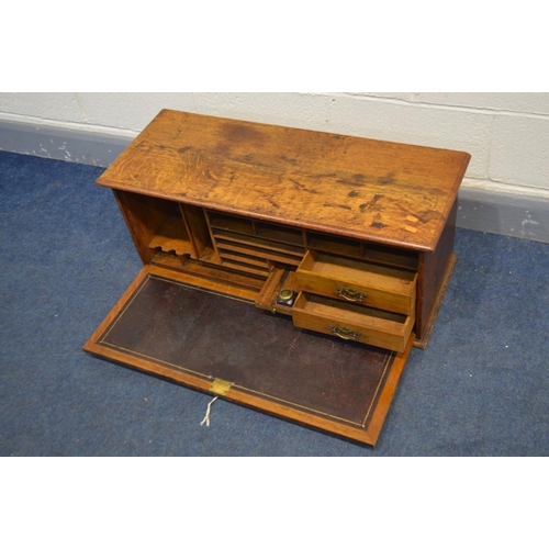 1252 - AN OAK TABLE TOP SECRETAIRE CABINET, with a fall front door with internal Burgandy leather inlay enc... 