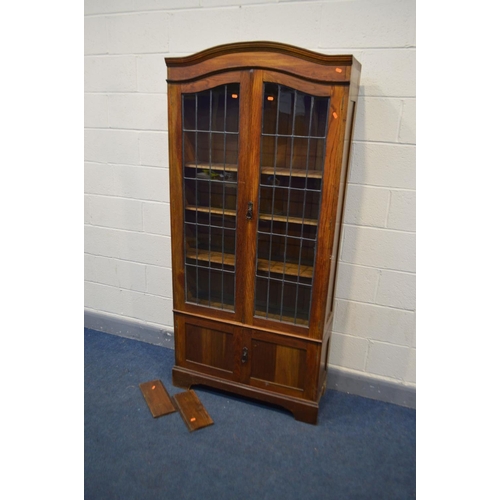 1255 - AN EARLY 20TH CENTURY OAK DOUBLE DOOR BOOKCASE, the lead glazed doors enclosing three adjustable she... 