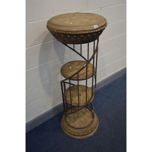 1257 - A CYLINDRICAL RESIN SHOP DISPLAY STAND, with a wrought iron gallery spiralling around three tier she... 