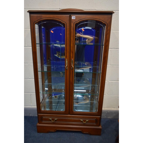 1258 - A CHERRYWOOD CHINA CABINET, with raised back, double doors enclosing three fixed glass shelves, abov... 