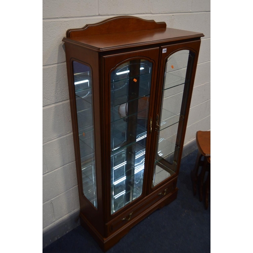 1258 - A CHERRYWOOD CHINA CABINET, with raised back, double doors enclosing three fixed glass shelves, abov... 