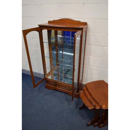 1258 - A CHERRYWOOD CHINA CABINET, with raised back, double doors enclosing three fixed glass shelves, abov... 