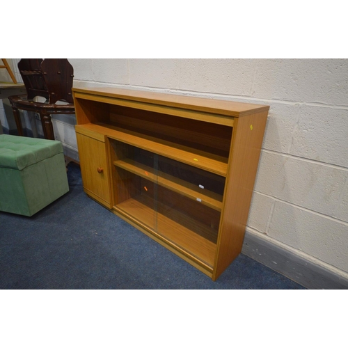 1259 - A TEAK EFFECT BOOKCASE with glass sliding doors, modern mahogany glass top side table, magazine rack... 