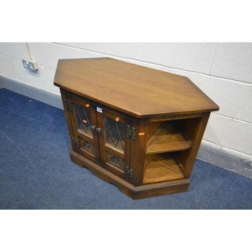 1261 - AN OAK OLD CHARM TV CABINET, double lead glazed doors enclosing a single shelf, width 103cm x depth ... 