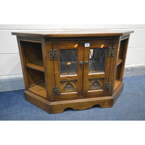 1261 - AN OAK OLD CHARM TV CABINET, double lead glazed doors enclosing a single shelf, width 103cm x depth ... 