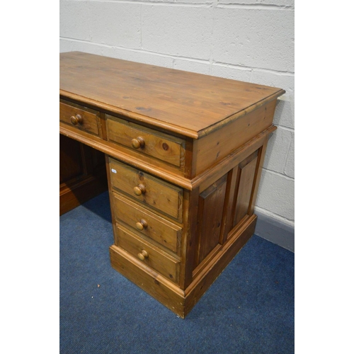 1267 - A PINE PEDESTAL DESK, with nine assorted drawers, width 138cm x depth 66cm x height 80cm