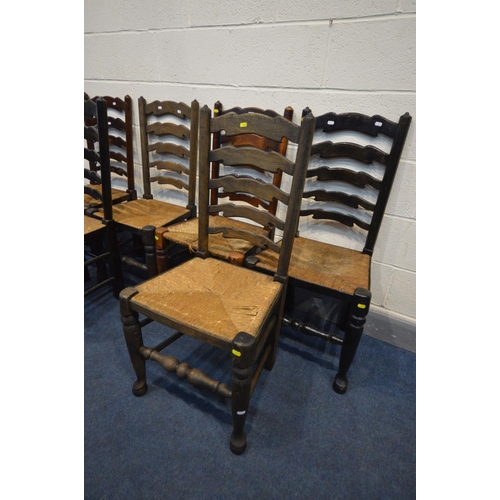 1290 - A SET OF SIX OAK RUSH SEATED LADDERBACK CHAIRS, all chairs varnished differently, along with spindle... 