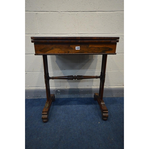 1299 - A REGENCY ROSEWOOD CARD TABLE, the fold over top enclosing an oval baize playing surface, single fri... 