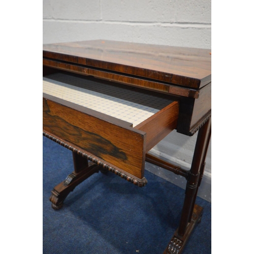 1299 - A REGENCY ROSEWOOD CARD TABLE, the fold over top enclosing an oval baize playing surface, single fri... 