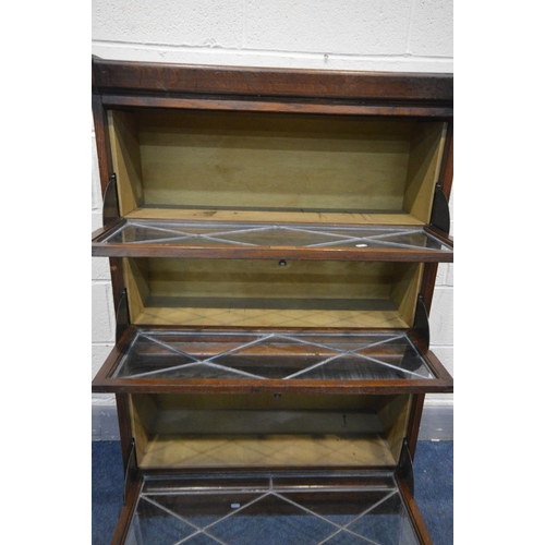 1333 - AN EARLY 20TH CENTURY OAK THREE SECTION BOOKCASE, lead glazed fall front doors and later internal pl... 