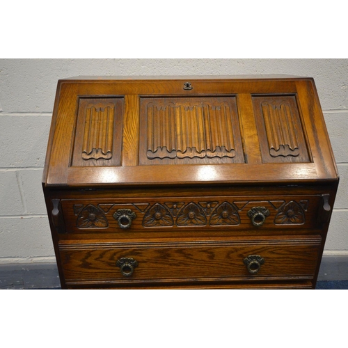 1343 - AN OAK OLD CHARM BUREAU, linenfold fall front above four long drawers, width 75cm x depth 48cm x hei... 