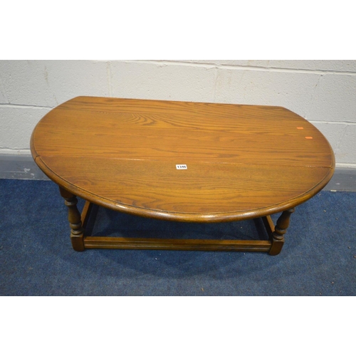 1346 - A LOW OAK OVAL TOP DROP LEAF COFFEE TABLE, length 107cm x open depth 96cm x closed length 53cm x hei... 