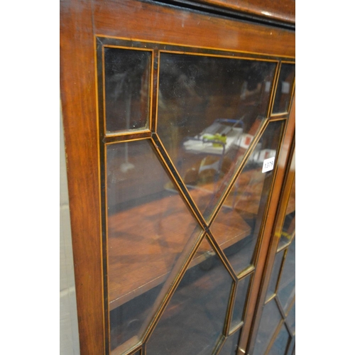 1379 - A GEORGIAN MAHOGANY TWO DOOR BOOKCASE, astragal glazing joined by inlaid partitions, enclosing five ... 