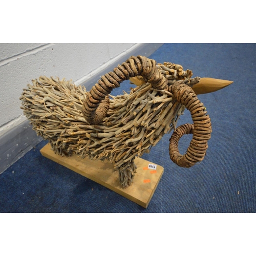 1388 - A TWIG SCULPTURE OF A RAM, on a wooden plinth, length 66cm