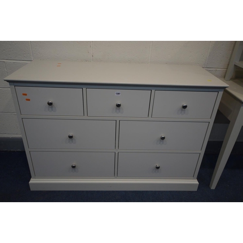 1397 - A CREAM FINISH FOUR PIECE BEDROOM SUITE, comprising a sideboard/chest of seven assorted drawers, wid... 