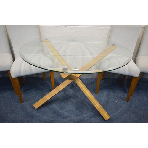 1402 - A CIRCULAR GLASS TOP DINING TABLE, on an oak cross framed base, diameter 107cm x height 72cm (Sd) an... 