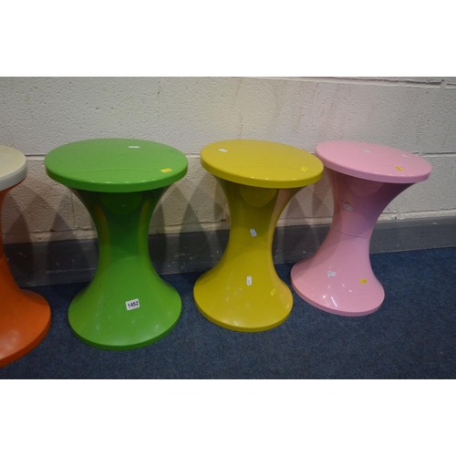 1452 - THREE TAM TAM CIRCULAR STOOLS, in three colours, along with a pair of similar stools stamped Judge (... 