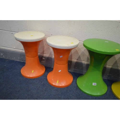 1452 - THREE TAM TAM CIRCULAR STOOLS, in three colours, along with a pair of similar stools stamped Judge (... 