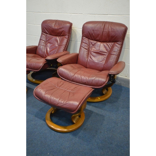 1480 - A PAIR OF EKORNES STRESSLESS BURGUNDY LEATHER RECLINING SWIVEL ARMCHAIRS and matching footstools (4)