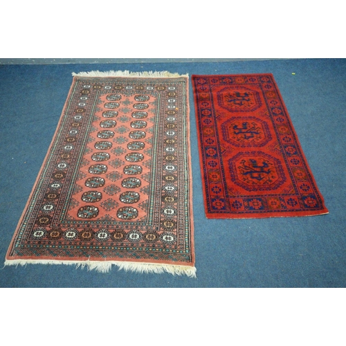 1486 - A LARGE WOOLLEN TABRIZ STYLE CARPET SQUARE, 346cm x 250cm and a pink tekke rug and a red rug (3)