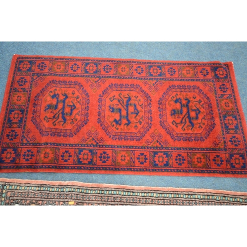 1486 - A LARGE WOOLLEN TABRIZ STYLE CARPET SQUARE, 346cm x 250cm and a pink tekke rug and a red rug (3)