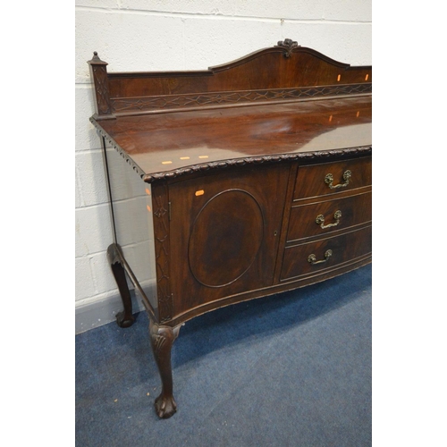 1503 - AN EDWARDIAN MAHOGANY SERPENTINE SIDEBOARD with a raised back with blind fretwork detail, on a base ... 