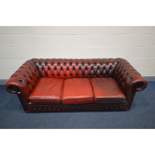 1504 - A BURGUNDY LEATHER CHESTERFIELD SOFA, Length 198cm (condition - cushions worn and cracking, but no r... 