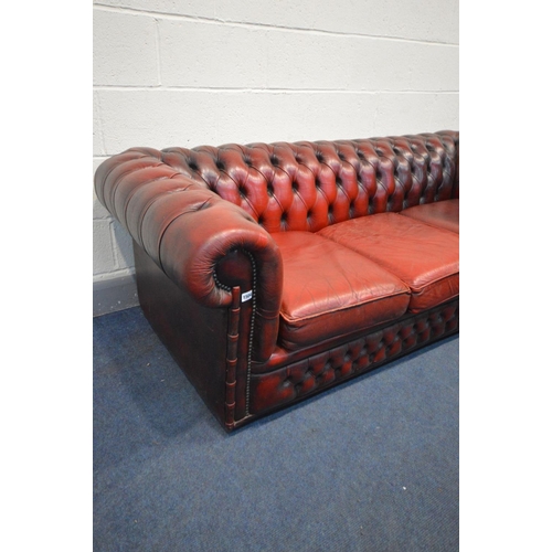 1504 - A BURGUNDY LEATHER CHESTERFIELD SOFA, Length 198cm (condition - cushions worn and cracking, but no r... 