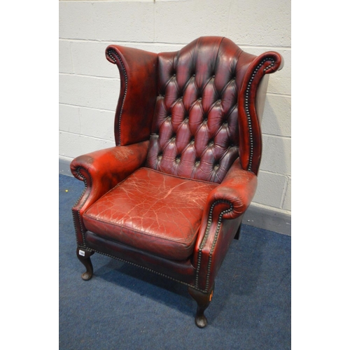 1505 - A BURGUNDY LEATHER BUTTONED WING BACK ARMCHAIR (condition - armrests worn, cracked and one rip, cush... 