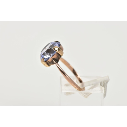 100 - A YELLOW METAL DRESS RING, designed with a claw set circular cut pale blue stone assessed as sapphir... 