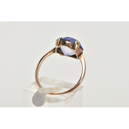 100 - A YELLOW METAL DRESS RING, designed with a claw set circular cut pale blue stone assessed as sapphir... 