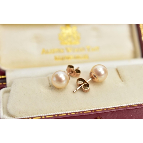 125 - A CASED PAIR OF CULTURED PEARL EARRINGS, each set with a single cultured pearl, yellow metal post an... 