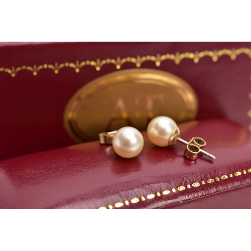 125 - A CASED PAIR OF CULTURED PEARL EARRINGS, each set with a single cultured pearl, yellow metal post an... 