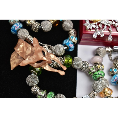 152 - A BOX OF ASSORTED WHITE METAL CHARM BRACELETS AND BROOCHES, to include thirteen white metal charm br... 