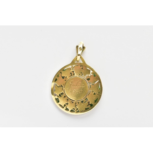 163 - A YELLOW METAL PENDANT, of a circular form depicting the virgin Mary within a surround of vine leave... 