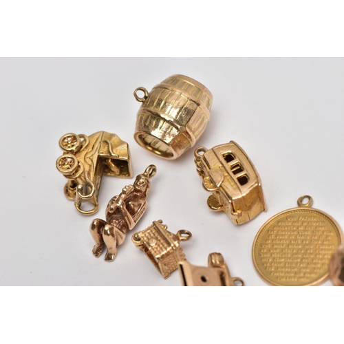 17 - NINE 9CT GOLD CHARMS, to include a barrel, a hinged caravan, a pram and a telephone, all with 9ct ha... 