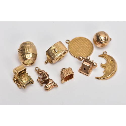 17 - NINE 9CT GOLD CHARMS, to include a barrel, a hinged caravan, a pram and a telephone, all with 9ct ha... 