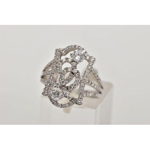 170 - A MODERN DIAMOND FANCY RING, designed as an open rectangular head of scroll design with two larger m... 