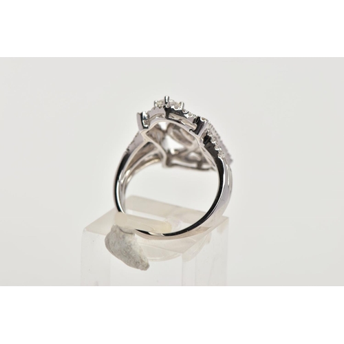 170 - A MODERN DIAMOND FANCY RING, designed as an open rectangular head of scroll design with two larger m... 