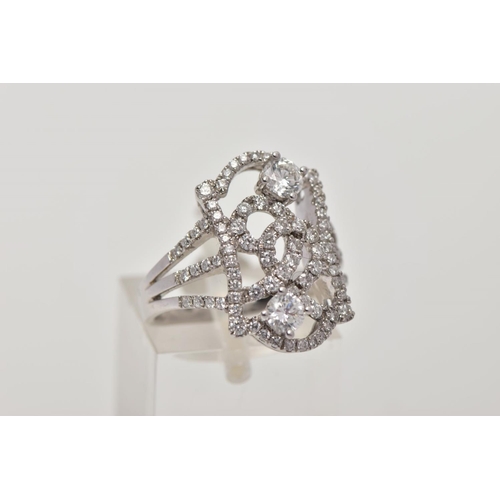 170 - A MODERN DIAMOND FANCY RING, designed as an open rectangular head of scroll design with two larger m... 