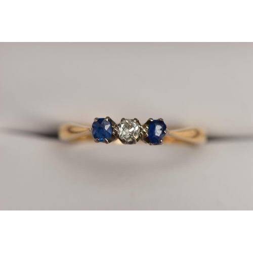 178 - A YELLOW METAL THREE STONE RING, designed with a central, claw set old cut diamond, flanked with cla... 