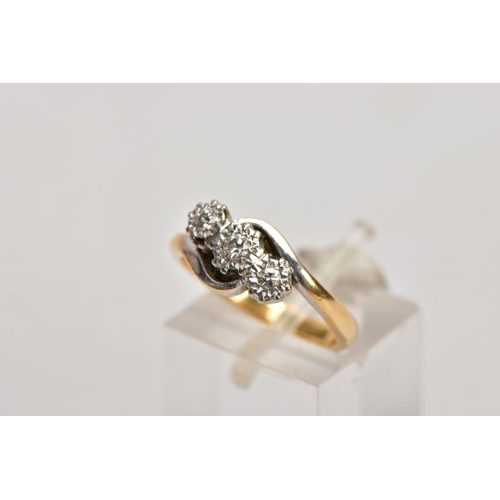 185 - A YELLOW METAL THREE STONE DIAMOND RING, designed with three graduated round brilliant cut diamonds,... 