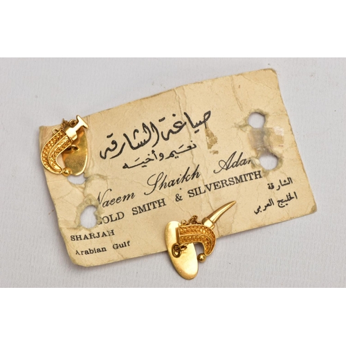 188 - A PAIR OF YELLOW METAL NOVLETY ARABIC CUFFLINKS, each in the form of a sheath and removeable dagger ... 