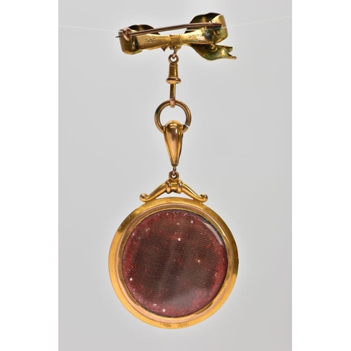 19 - AN EARLY 20TH CENTURY 9CT GOLD PORTRAIT BROOCH, the circular double sided photo pendant, with painte... 