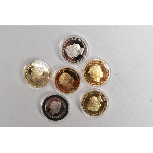 206 - A PACKET OF 2017 ROYALTY GUILDED AND PHOTOGRAPHIC GIBRALTAR ONE CROWN COINS six coins